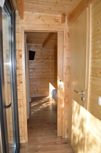 a sauna in a wooden cabin with a door at Bamboo Guest House in Águeda