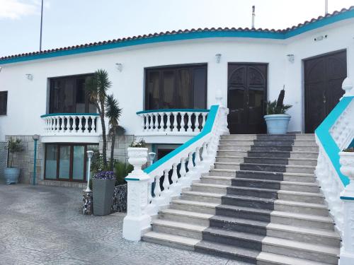 a white house with stairs in front of it at Residence R&B Tyrrhenum in Monte di Procida