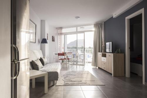 a living room with a couch and a table at Full center of Las Americas, renovated, high floor in Playa de las Americas