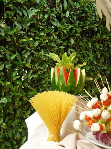 a table with a plant and a plate of food at Grand Hotel President in Spilimbergo