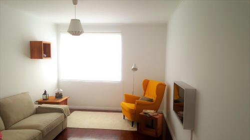 a living room with a couch and a chair at Praia Mar in Ribeira Grande