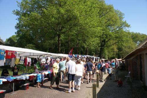 a large group of people walking around a market at Under the Oaks in Diever