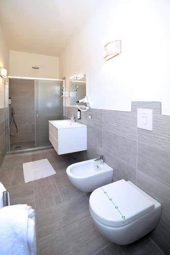 a bathroom with a toilet and a sink and a shower at The Stunning B&B in Peschici