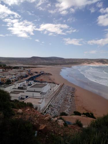 a view of a beach with buildings and the ocean at Aziki in Essaouira
