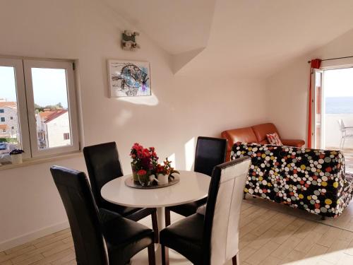 a living room with a table and chairs and a couch at Apartments Antonio in Cavtat