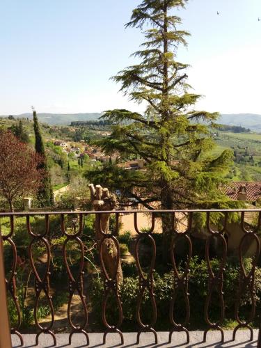 a view of a tree from a iron fence at Casa Volpini in Panzano