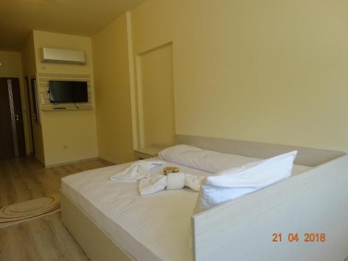 a hotel room with a bed with towels on it at Hotel Lago Peshtera in Peshtera