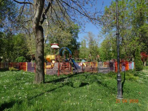 a park with a playground in the grass at Hotel Lago Peshtera in Peshtera
