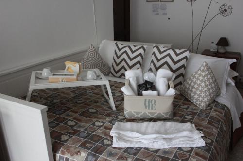 a bedroom with a bed with a table and a box on it at BiancoCancello in Sacrofano