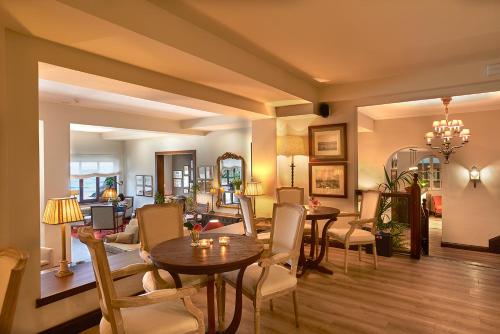 a living room with two tables and chairs at Hotel Mirador de La Franca in La Franca