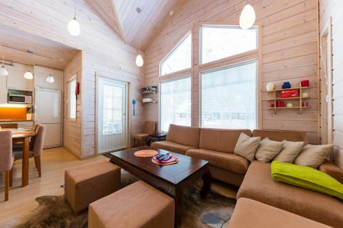 a living room with a couch and a table at LevinSatu: SeLevi and TaLevi Apartments in Levi