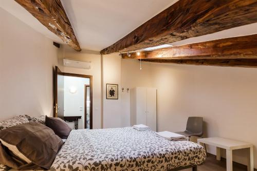 a bedroom with a bed and a desk and a chair at Attic at the Park in Trieste