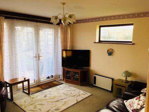 a living room with a large window and a television at Dream On in St Margarets at Cliff