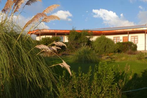 a house with a garden in front of a building at Terrace Lodge in Putre