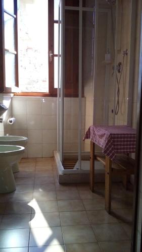 a bathroom with a shower and a table in it at Little B&B Della Pieve in Panzano