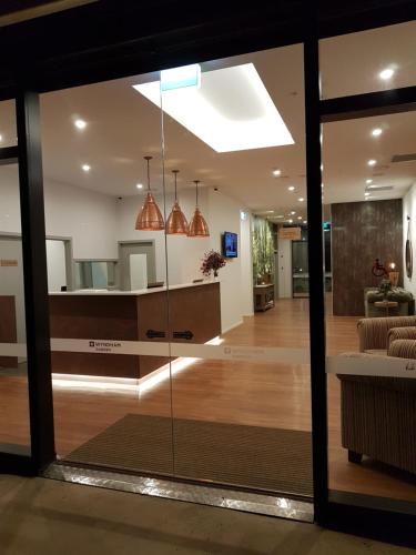 a view of a living room through a glass door at Wyndham Garden Remarkables Park Queenstown in Queenstown