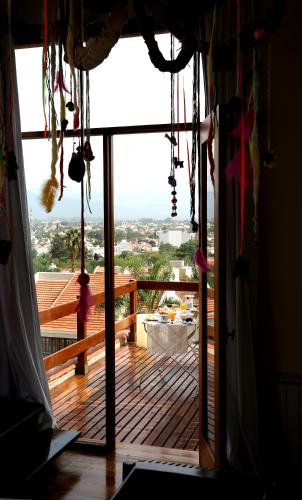 an open door to a deck with a view at Kkala Boutique Hotel in Salta