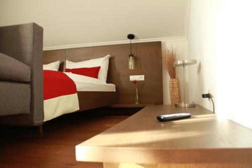 a bedroom with a bed with red and white pillows at Frühstückspension Bachseitenhof in Radstadt