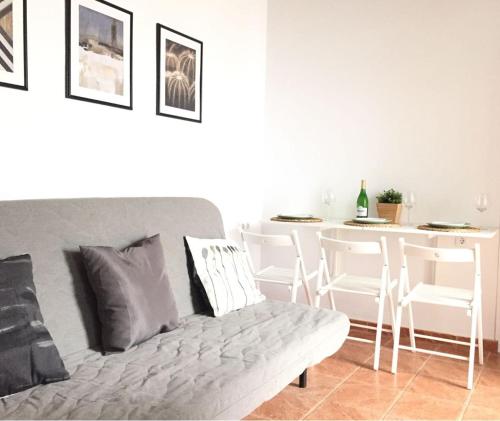 a living room with a couch and a table at CH Apartments in Conil de la Frontera