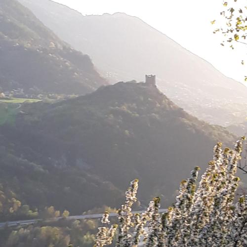 a hill with a castle on top of it at il Battito in Saint Vincent