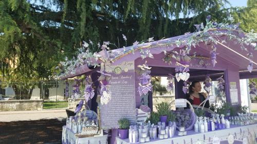 a purple building with a display of bottles of perfume at Villa La Baia a pochi passi dal lago in San Felice del Benaco