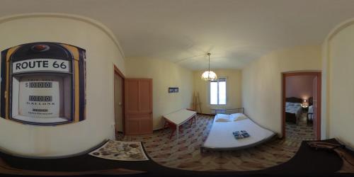 a hotel room with a bed and a clock on the wall at Chez'Artistes in Argelès-sur-Mer