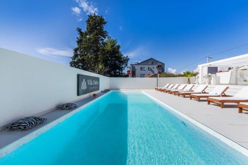 a swimming pool on the roof of a house at Villa Zadar Superior in Zadar