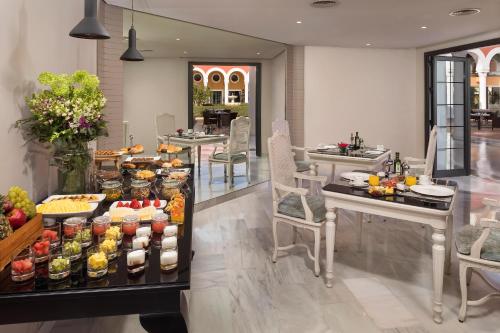 
a kitchen filled with lots of different types of food at Gran Meliá Sancti Petri in Chiclana de la Frontera
