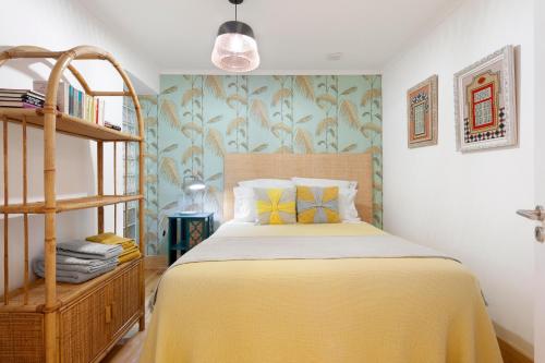 a bedroom with a bed with a yellow blanket at FeelingLisbon Tejo in Lisbon