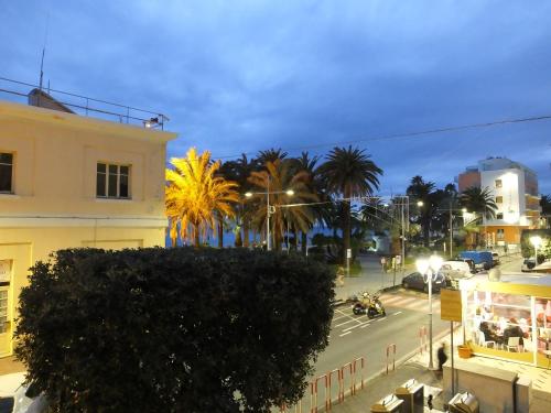 a city street with palm trees and a building at Casa Amico Mare in Loano