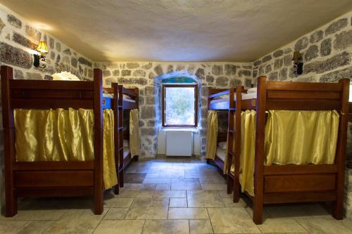 a room with two bunk beds and a window at Old Town Youth Hostel in Kotor