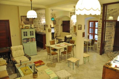 a kitchen and living room with a table and chairs at Old Town Youth Hostel in Kotor