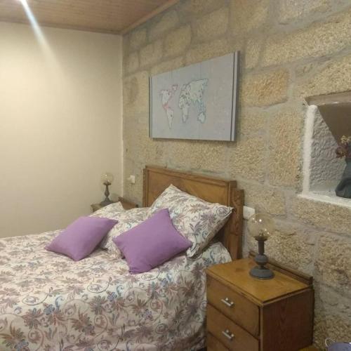 a bedroom with a bed with two purple pillows at La Torre Mondariz in Mondariz