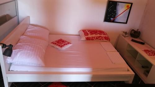 a bed with two pillows on it in a room at Apartments with a parking space Mali Iz (Iz) - 15278 in Veli Iž