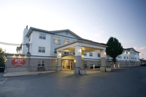 a hotel building with a sign that reads first inn at Host Inn an All Suites Hotel in Wilkes-Barre