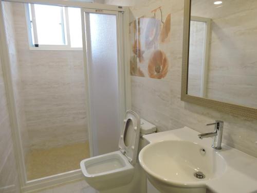 a bathroom with a sink and a toilet and a shower at Deer House in Yongan
