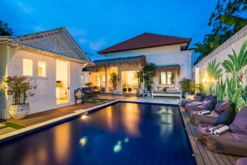 a swimming pool in the backyard of a house at Gypsy Moon Bali in Canggu