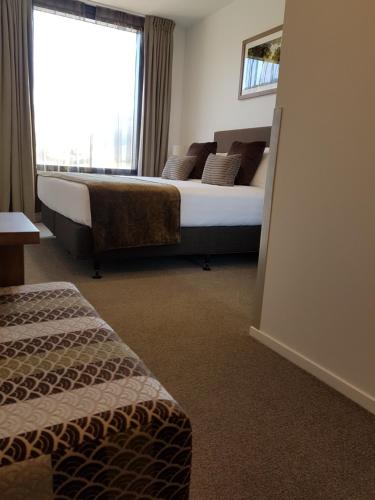 a hotel room with a bed and a window at Wyndham Garden Remarkables Park Queenstown in Queenstown