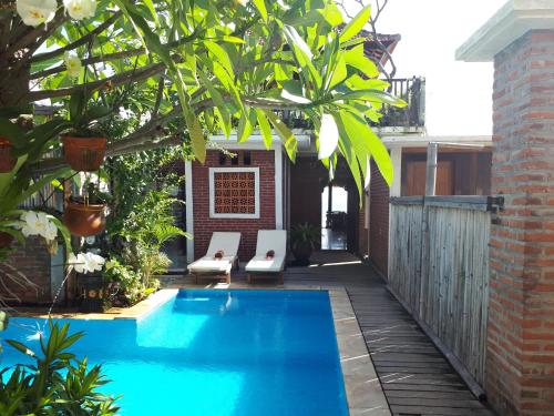 a swimming pool in the backyard of a house at Amed Sunset Beach in Amed