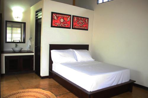 a bedroom with a bed and a sink in it at Hotel Amazon Bed And Breakfast in Leticia
