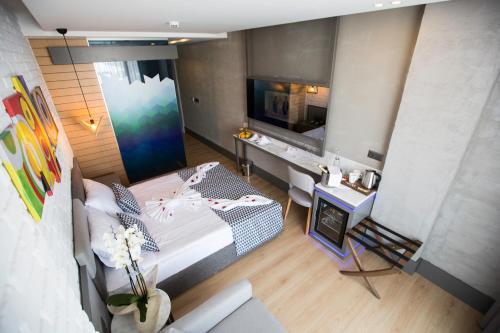 a bedroom with a bed and a tv in a room at Laren Family Hotel & Spa - Boutique Class in Antalya