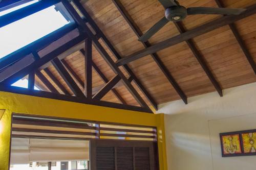 a room with wooden ceilings and a ceiling fan at Hotel Amazon Bed And Breakfast in Leticia