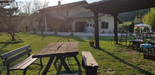 a wooden picnic table in the yard of a house at Agriturismo Santa Giusta in Poggio San Lorenzo