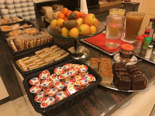 a buffet of cookies and other pastries on a counter at Hotel Adsubia in Denia