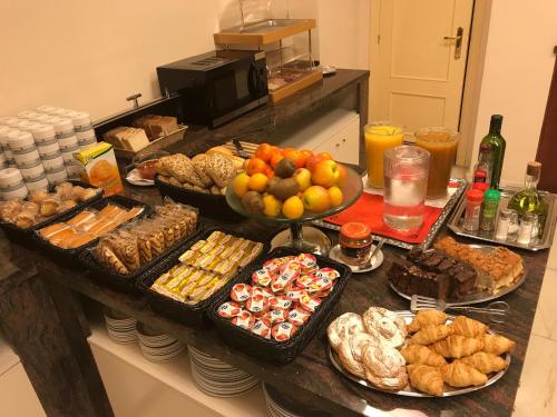 a buffet with many different types of food on a counter at Hotel Adsubia in Denia