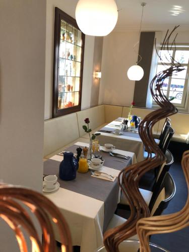 a dining room with a table and two chairs at Hotel Friedrich in Hachenburg