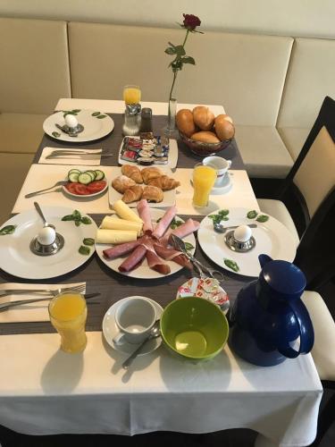 a table with plates of food on it at Hotel Friedrich in Hachenburg