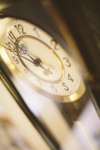 a close up of a clock on a table at Penzion Berc in Bled