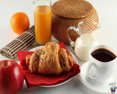 a plate of food with an apple and a cup of coffee at iGV Club Baia Samuele in Sampieri