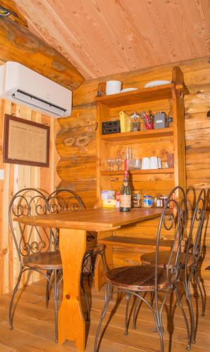 a dining room with a wooden table and chairs at Les Cabanes Du Saleve in Collonges-sous-Salève
